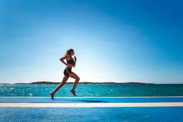 Woman running showing strong leg muscle Corby